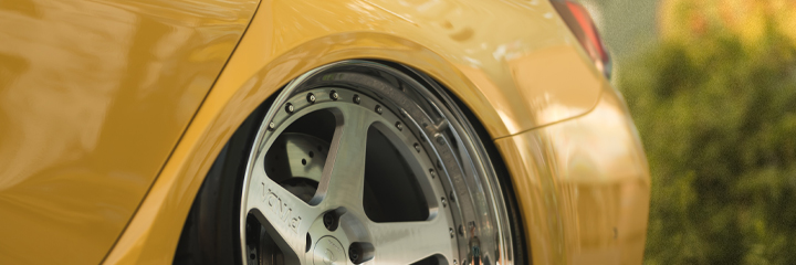 Rear shot of yellow BMW G80 M3 bagged on Bag Riders Super Low air suspension
